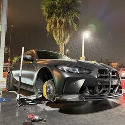 Car lifted, wheel removed, tire patched off screen Car lifted, wheel removed, tire patched off screen