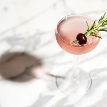 Forsythia - a glass of wine with a sprig of rosemary - Italian Near Me - New York, New York