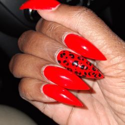 Red stiletto nails with print