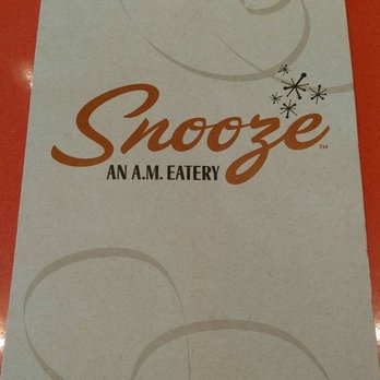 Snooze, an A.M. Eatery - Partial view of a menu cover - Breakfast & Brunch Near Me - San Diego, California Snooze, an A.M. Eatery - Partial view of a menu cover - Breakfast & Brunch Near Me - San Diego, California