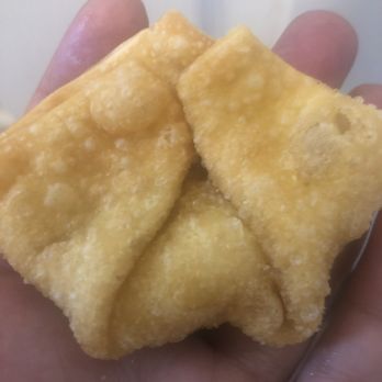 Ling Ling Kitchen - a hand holding a piece of food - Chinese Near Me - Ithaca, New York