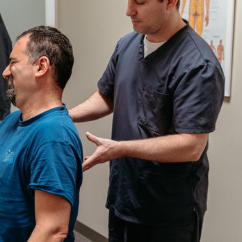 Plainfield Spine And Rehabilitation, Dr. McCarthy Chiropractor - Dr. Paul McCarthy adjusting a patient - Chiropractors Near Me - Plainfield, Illinois