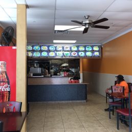 a woman sitting at a table in a fast food restaurant