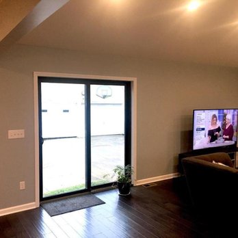Father & Son Construction - a living room with sliding glass doors - General Contractors Near Me - Troy, Michigan