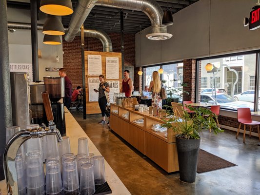 Photo of Mildred's - Kansas City, MO, US. The large industrial space is warmed up by wood fixtures and greenery.