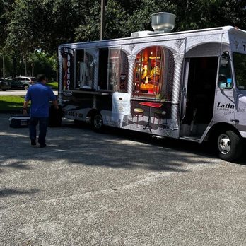 Dochos Latin Bistro - a man standing in front of a food truck - Food Trucks Near Me Dochos Latin Bistro - a man standing in front of a food truck - Food Trucks Near Me