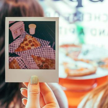 Favorite Pizza - a woman holding up a polaroid picture - Pizza Near Me - Austin, Texas Favorite Pizza - a woman holding up a polaroid picture - Pizza Near Me - Austin, Texas