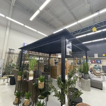 Big Lots - Furniture and home decor items, including plants and seating, are arranged under a black canopy inside Big Lots in Schererville, Indiana. - Department Stores Near Me - Schererville, Indiana