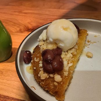 Mara - Complementary dessert of ....topped with candied grapes, ice cream and a honey drizzle. Delicious - Mediterranean Near Me - Honolulu, Hawaii