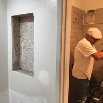 Elite Energy Home Improvement - a man working on a bathroom wall - General Contractors Near Me Elite Energy Home Improvement - a man working on a bathroom wall - General Contractors Near Me