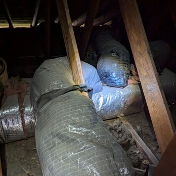 AFM Heating & Cooling - Flex duct wrapped around a board using two 90 degree turns. No straps were placed and the duct wasn't pulled smooth. - Heating & Air Conditioning/HVAC Near Me - Livonia, Michigan
