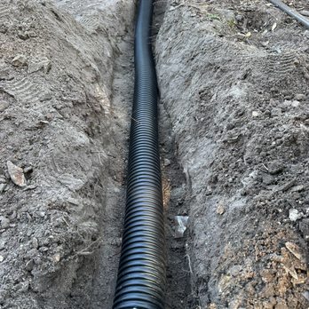 Martz Land Services - downspout drain line installation to guide to water out of your landscape planter bed. - Irrigation Near Me Martz Land Services - downspout drain line installation to guide to water out of your landscape planter bed. - Irrigation Near Me