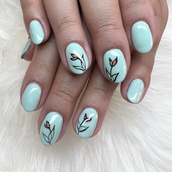 Omani  - Close-up of manicured fingernails painted with light blue gel polish. Several nails display black line art floral designs with pink accents, creating a delicate and artistic look. The nails are well-shaped and glossy, set against a soft, textured background. - Nail Salons Near Me - Chicago, Illinois