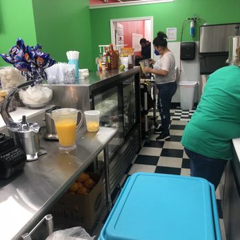 Fruti Raspados Mary - a woman preparing food in a kitchen - Shaved Ice Near Me - Gaithersburg, Maryland
