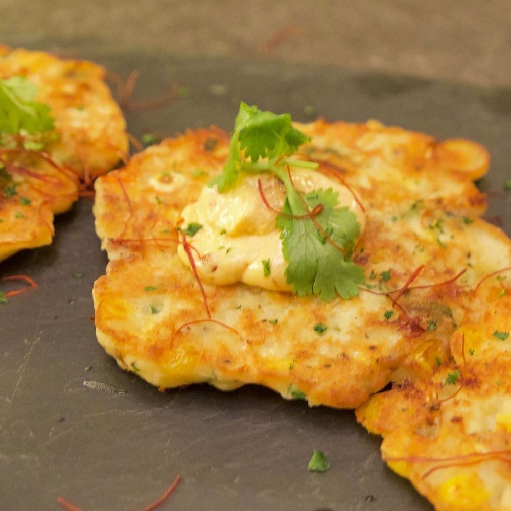 Cabernet Grill - skillet corn fritters topped with spicy local goat cheese - Seafood Near Me - Fredericksburg, Texas