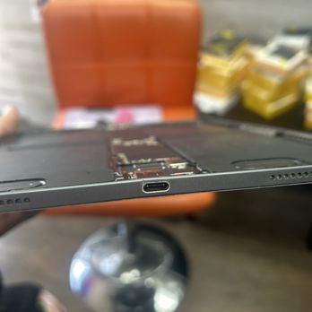 Ultimate Wireless Solutions Mobile Phone Repair Tustin - Cracked Fram due to technician shoving cheap charging port into ipad frame - Mobile Phone Repair Near Me - Tustin, California