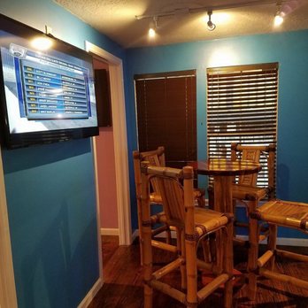 The Daiquiri Hut - a dining room with a flat screen tv - Pubs Near Me - Kemah, Texas
