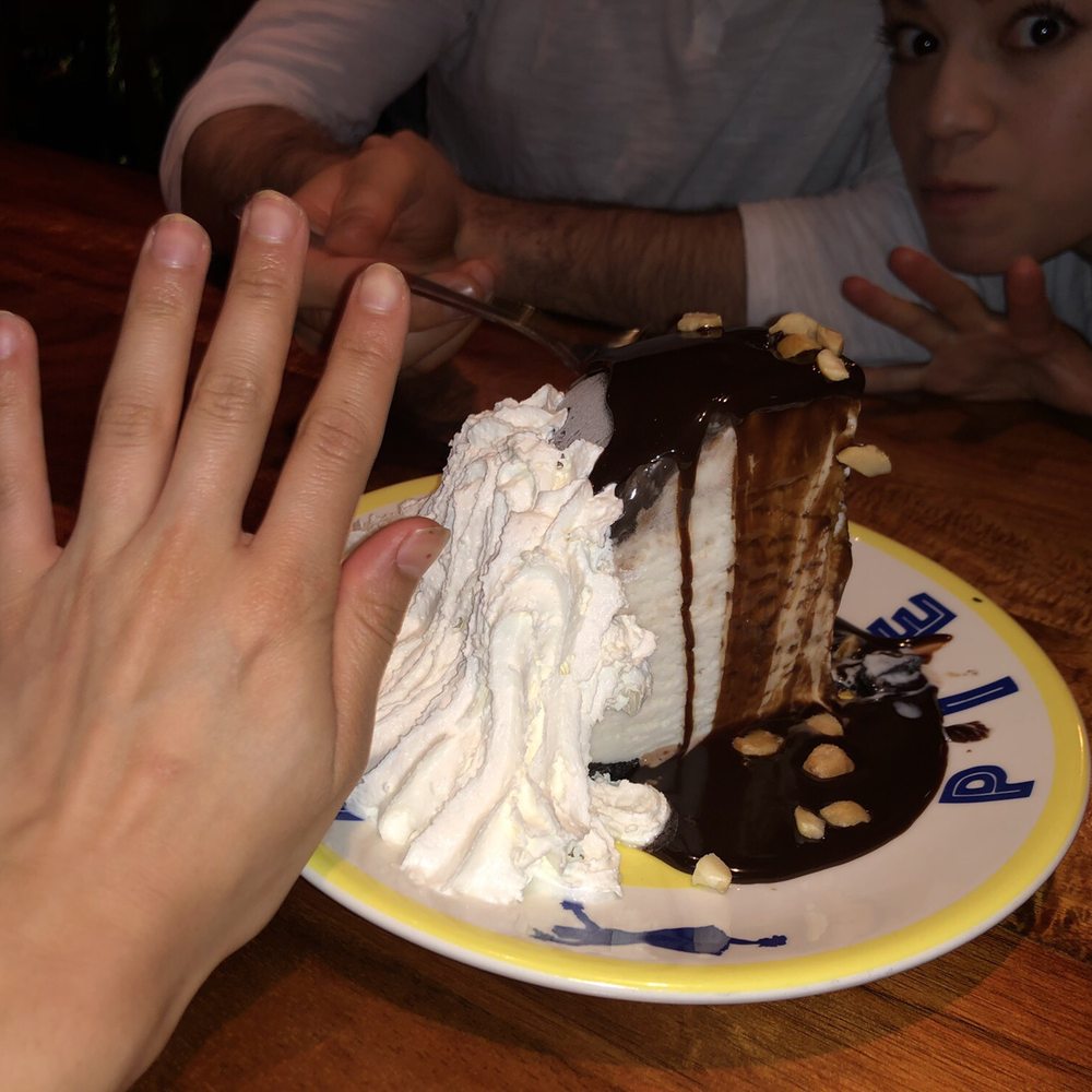 Keoki's Paradise - Ice cream cake dessert. Compared to my hand so you can see how big it is. Everyone in the restaurant orders this. Free if it's your birthday - Seafood Near Me - Koloa, Hawaii