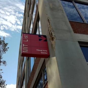 MIT List Visual Arts Center - A sign on MIT Building E19 points toward the List Visual Arts Center (is it also pointing out the damaged concrete as art?) - Art Galleries Near Me - Cambridge, Massachusetts MIT List Visual Arts Center - A sign on MIT Building E19 points toward the List Visual Arts Center (is it also pointing out the damaged concrete as art?) - Art Galleries Near Me - Cambridge, Massachusetts