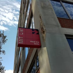 A sign on MIT Building E19 points toward the List Visual Arts Center (is it also pointing out the damaged concrete as art?)