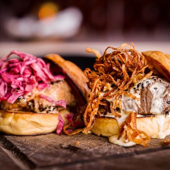 Kitchen and Rail - two burgers on a cutting board - Bars Near Me - Eagan, Minnesota Kitchen and Rail - two burgers on a cutting board - Bars Near Me - Eagan, Minnesota