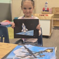 Village Daycare - On Earth Day the kids learned about taking care of our planet, my daughter repurposed books into art and made a spaceship.