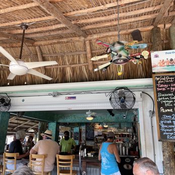 Fish Camp - a group of people sitting at a restaurant - New American Near Me - Key West, Florida