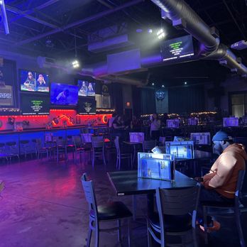 Revel Patio Grill - a man sitting at a table - Sports Bars Near Me - Frisco, Texas