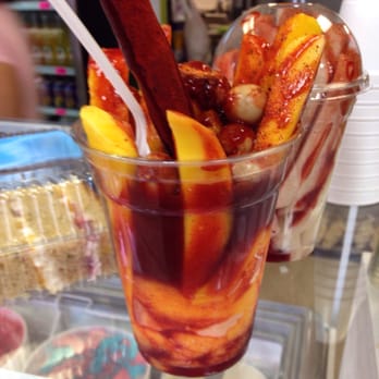 Las Fresas - Mango sorbet. Mangos. Japanese peanuts. Tamarind candy pieces and straw. Chamoy sauce. Lime. Chili powder - Desserts Near Me - Aurora, Colorado