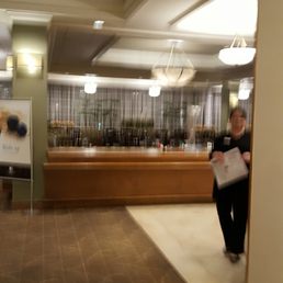 a woman walking through a hotel lobby