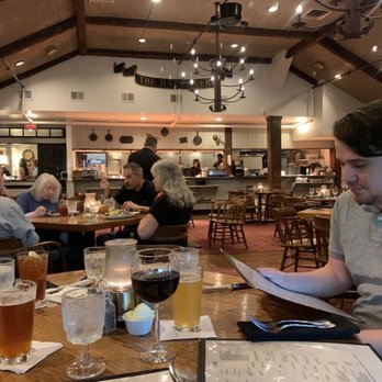 Barnsider - a man sitting at a table reading a menu - Steakhouses Near Me - Albany, New York