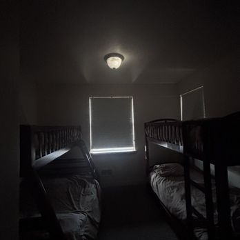 Happy Camp Hideaway - Five beds in tiny bedroom with very dim light. - Resorts Near Me - Tillamook, Oregon