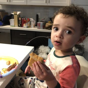 Dunkin' - a toddler sitting in a high chair eating a sandwich - Donuts Near Me - Salem, Massachusetts Dunkin' - a toddler sitting in a high chair eating a sandwich - Donuts Near Me - Salem, Massachusetts