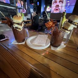 Three Monkeys Pub - Legendary Bloody Mary. ZigZang bloody mix, celery, pickle, olives, 2 bacon, 2 buffalo wings and 2 sliders