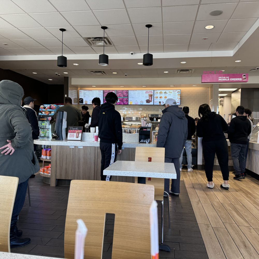 customers in a dunkin donuts restaurant customers in a dunkin donuts restaurant