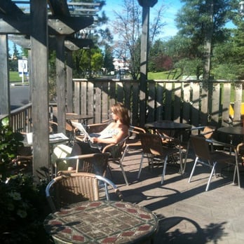 Good Earth Coffeehouse - a woman sitting at a table - Coffee & Tea Near Me - Calgary, Alberta Good Earth Coffeehouse - a woman sitting at a table - Coffee & Tea Near Me - Calgary, Alberta