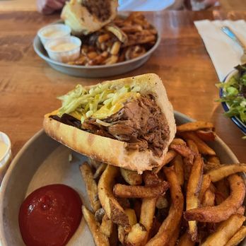 Caledon Hills Brewing - A brisket sandwich shared between two plates. - Brewpubs Near Me - Palgrave, Ontario
