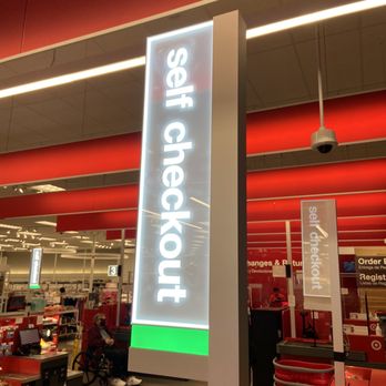 Target - Great check out area - A tall, illuminated sign with the words 'Self Checkout' in white text on a light background is visible inside a retail store, with checkout counters and shopping carts in the background. - Furniture Stores Near Me - Costa Mesa, California