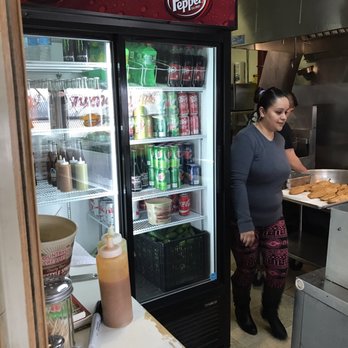 Taqueria Ochoas - a woman serving food to a customer - Mexican Near Me - Chicago, Illinois