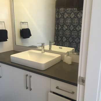 To The Max Construction - a bathroom with a sink and mirror - General Contractors Near Me