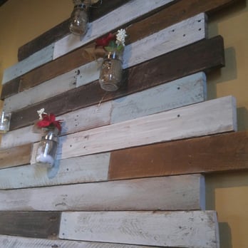 252 Grill - a wooden wall decorated with mason jars - Burgers Near Me - Hertford, North Carolina
