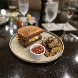 Tavern N Town - TNT sandwich on toast with delicious wedges sautéed in oil, peppers, onion and seasoning & served with Chef's own spicy vinegar.