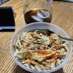 a bowl of noodles and a drink
