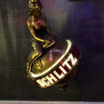 Surf Club - a statue of a woman sitting on a globe - Bars Near Me - Durham, North Carolina Surf Club - a statue of a woman sitting on a globe - Bars Near Me - Durham, North Carolina