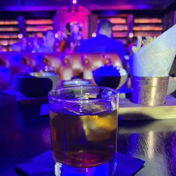 The Library - Old Fashion with a cool branded Nomad ice cube - New American Near Me - Las Vegas, Nevada The Library - Old Fashion with a cool branded Nomad ice cube - New American Near Me - Las Vegas, Nevada