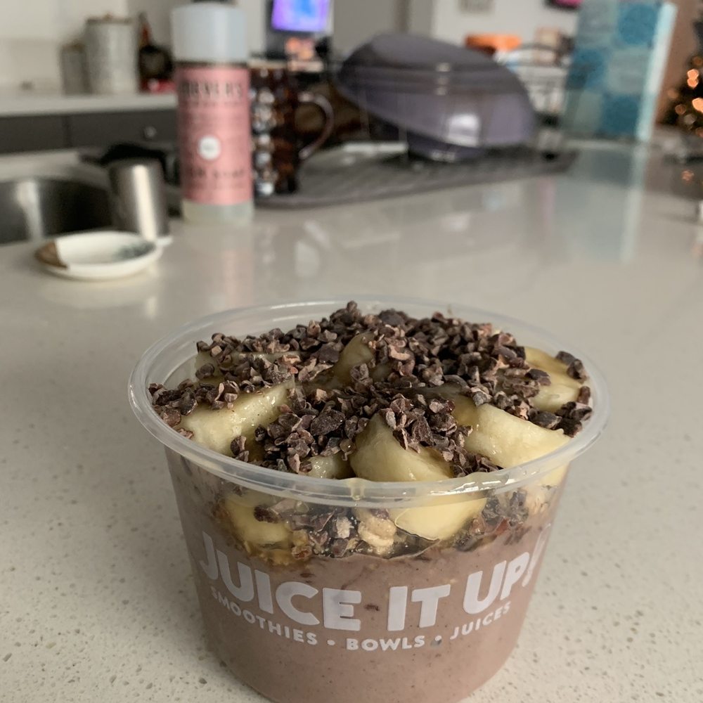 Juice It Up! - Protein açaí bowl with bananas, cacao nibs, and hemp granola drizzled with honey - Juice Bars & Smoothies Near Me - Rancho Cucamonga, California