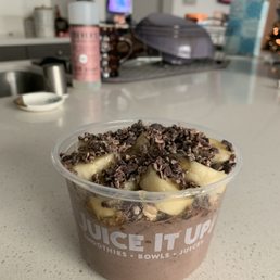 Protein açaí bowl with bananas, cacao nibs, and hemp granola drizzled with honey Protein açaí bowl with bananas, cacao nibs, and hemp granola drizzled with honey