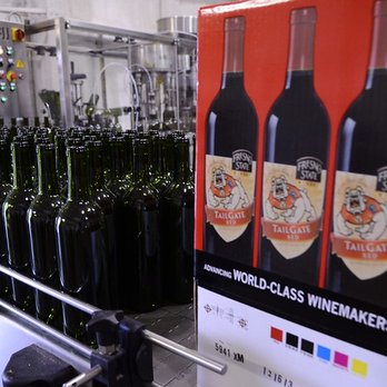 Fresno State Winery - a line of bottles being filled with wine - Wineries Near Me - Fresno, California Fresno State Winery - a line of bottles being filled with wine - Wineries Near Me - Fresno, California