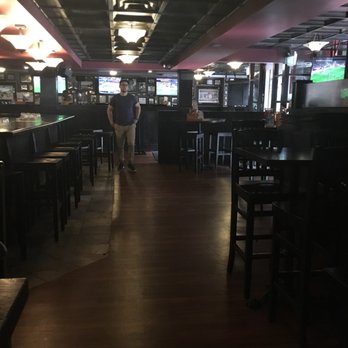Pint Public House - a man standing in a bar - Sports Bars Near Me - Halifax, Nova Scotia