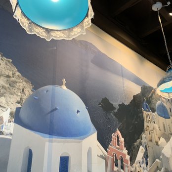 Santorini Mediterranean - The scenery of Santorini is featured on the wall and transports you to that magical island - Mediterranean Near Me - Danville, California Santorini Mediterranean - The scenery of Santorini is featured on the wall and transports you to that magical island - Mediterranean Near Me - Danville, California